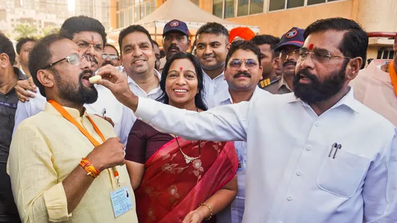 Maharashtra Chief Minister Eknath Shinde feeds sweets to Shiv Sena candidate from Thane constituency Naresh Mhaske as the latter leads in the Lok Sabha elections amid the counting of votes, in Thane district, Tuesday, June 4, 2024
