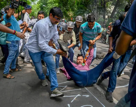 A member of Bharatiya Janata Yuva Morcha being detained at a protest against the alleged violence during West Bengal Panchayat elections, near West Bengal State Election Commission office in Kolkata