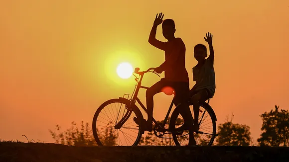A boy rides a bicycle during the last sunset in Joypur village, on the outskirts of Agartala, Sunday, Dec. 31, 2023.