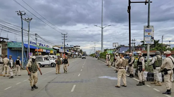 police patrolling on a road in Manipur