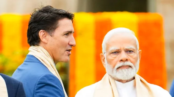 Canada's Prime Minister Justin Trudeau, left, walks past India's Prime Minister Narendra Modi as they take part in a wreath-laying ceremony at Raj Ghat during the G20 Summit in New Delhi