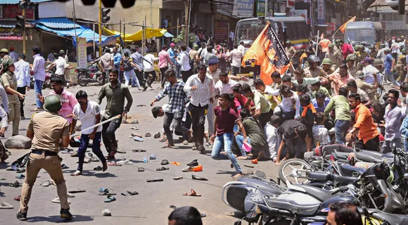 Security personnel disperse people protesting against the alleged use of Tipu Sultan’s image in objectionable social media posts, in Kolhapur