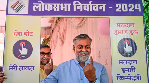 Madhya Pradesh minister and BJP leader Prahlad Patel shows his inked finger at a selfie stand after casting his vote for the second phase of Lok Sabha elections, in Narsinghpur, Friday, April 26, 2024