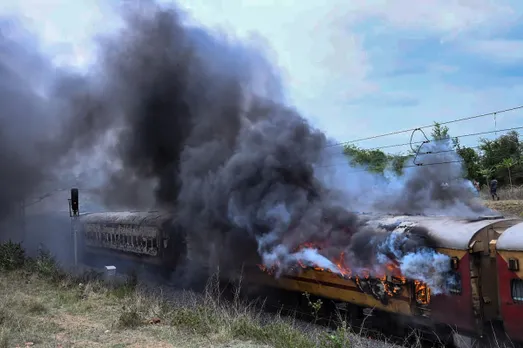 Smoke billows from the Falaknama Express train after it caught fire, in Yadadri Bhuvanagiri district, Telangana