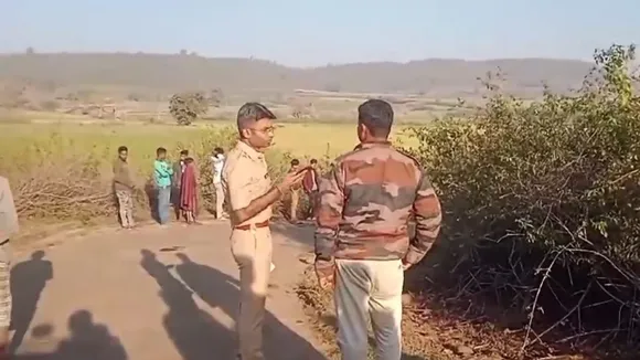 Police personnel near the site of an accident in which 14 people were killed and 20 others injured when a pick-up vehicle overturned, in Dindori