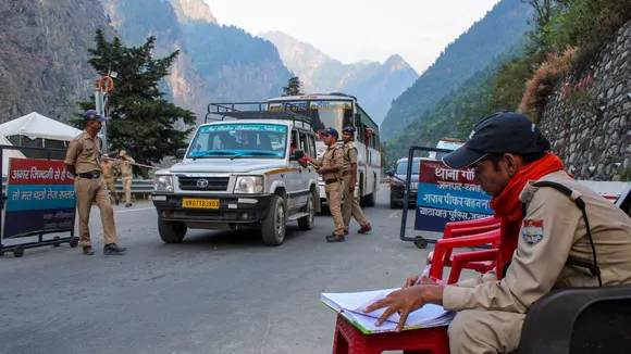 Police personnel check registration of 'Char Dham Yatra' pilgrims on a road leading to Badrinath temple, in Chamoli district, Tuesday, May 23, 2024