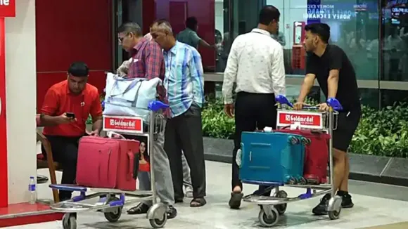 Passengers come out after the Air India flight from Dhaka arrived at the airport in New Delhi
