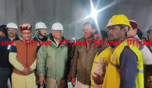 Pushkar Singh Dhami and VK Singh with the first worker rescued from Silkyara tunnel