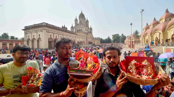 Devotees stand in a queue to offer prayers at Dakshineswar Kali Temple on the occasion of Bengali New Year, in Kolkata, Sunday, April 14, 2024