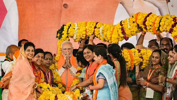 Prime Minister Narendra Modi being garlanded during BJP's 'Karyakarta Mahakumbh', in Bhopal