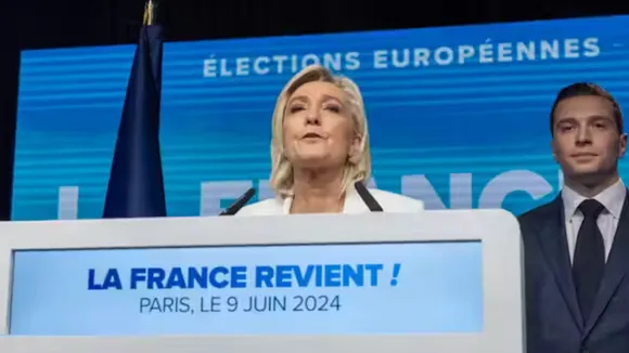 Marine Le Pen delivers a speech next to National Rally president Jordan Bardella after the first results of the European elections