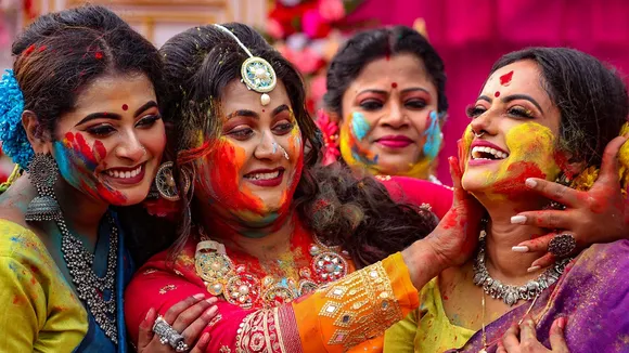 Women play Holi at Balurghat in South Dinajpur district of West Bengal, Sunday, March 24, 2024