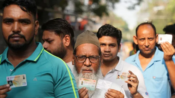 People wait in queues to cast their votes during the sixth phase of Lok Sabha elections, at a polling booth in East Delhi, Saturday, May 25, 2024