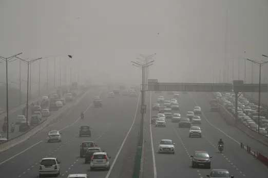 Vehicles ply on a road as the air quality deteriorates due to dust pollution, in New Delhi, Tuesday morning