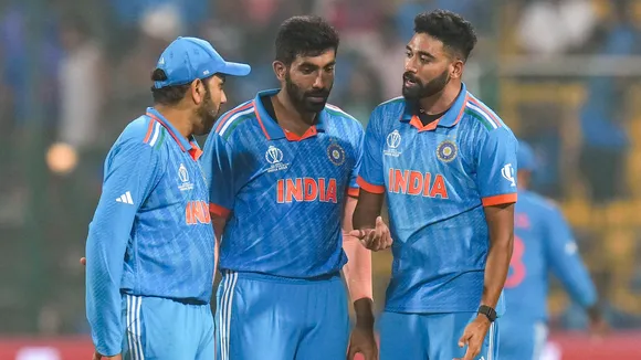 Mohammed Siraj with Jasprit Bumrah and captain Rohit Sharma celebrates the wicket of Netherlands' Sybrand Engelbrecht during the ICC Men's Cricket World Cup match between India and Netherlands, at M Chinnaswamy Stadium in Bengaluru, Sunday, Nov. 12, 2023