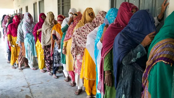 Voters wait in a queue to cast their votes at a polling station at Ghasera village during the Haryana Assembly elections, in Nuh district, Saturday, Oct. 5, 2024.