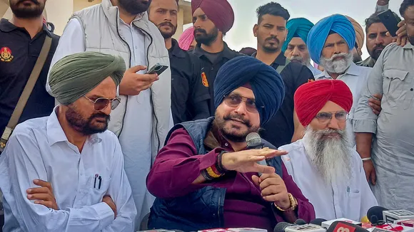 Congress leader Navjot Singh Sidhu with slain singer Sidhu Moosewala's father Balkaur Singh speaks to media in Mansa on April 3