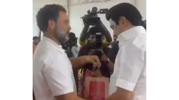Congress leader Rahul Gandhi giving Mysore Pak to DMK president M K Stalin on Saturday