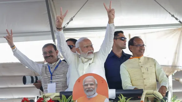 Narendra Modi waves at supporters as he arrives for an event organised for laying of foundation stone of various developmental projects, in Gwalior, Monday, Oct. 2, 2023. Madhya Pradesh Chief Minister Shivraj Singh Chouhan and MP BJP President VD Sharma are also seen.