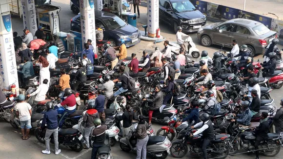 People wait in a long queue to get fuel amid 'rasta roko' protests by truck drivers in many parts of Maharashtra, in Nagpur, Tuesday, Jan. 2, 2024. Truckers are protesting against the provision in the new penal law regarding hit-and-run road accident cases involving motorists.