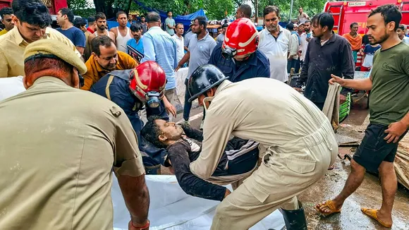 A person being rescued after a wall of a 'dargah' collapsed at Nabi Karim area, in New Delhi, Friday, Sept. 13, 2024.
