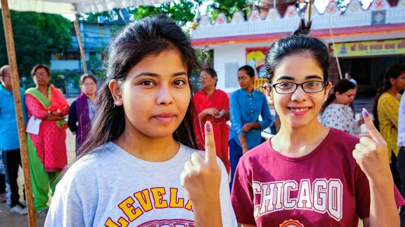 Young voters show their fingers marked with indelible ink after casting their vote for the third phase of Lok Sabha elections, in Bhopal, Tuesday, May 7, 2024