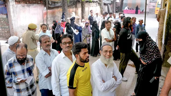 People wait in queues to cast their votes at a polling station during the fourth phase of Lok Sabha elections, in Kanpur, Monday, May 13, 2024. 