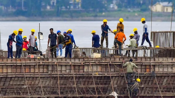 Workers construct a bridge over the Brahmaputra river, in Guwahati, Tuesday, July 23, 2024