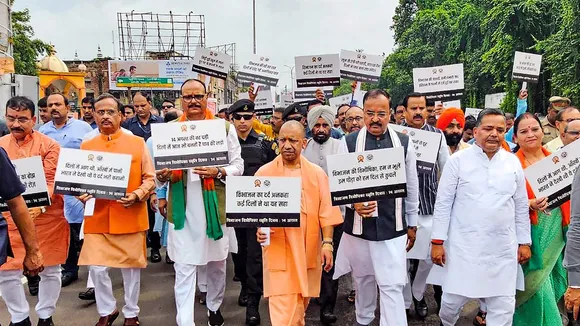 Uttar Pradesh Chief Minister Yogi Adityanath with Deputy CMs Keshav Prasad Maurya and Brajesh Pathak undertaking a silent march to commemorate the victims on 'Partition Horrors Remembrance Day', in Lucknow, Wednesday, Aug. 14, 2024.