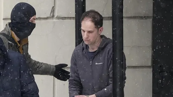 Wall Street Journal reporter Evan Gershkovich is escorted from a court hearing in Moscow, Russia, on Friday, Jan. 26, 2024. 