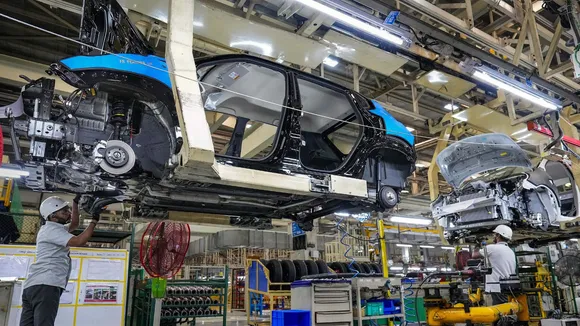 Employees work in an assembly line at the joint manufacturing facility of Renault-Nissan Automotive India Pvt Ltd, near Chennai, Wednesday, March 27, 2024