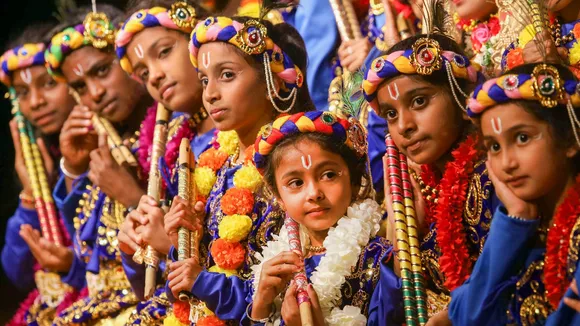 Children dressed as Lord Krishna take part in Janmashtami festival celebrations
