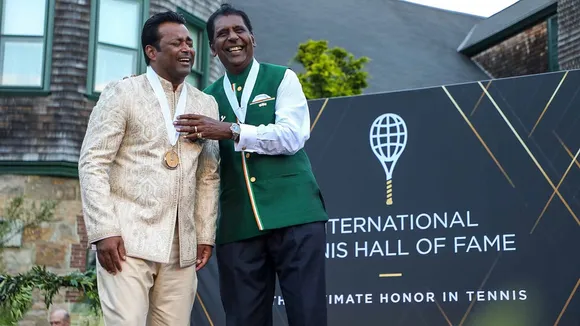Leander Paes and Vijay Amritraj share a laugh following their induction into the International Tennis Hall of Fame