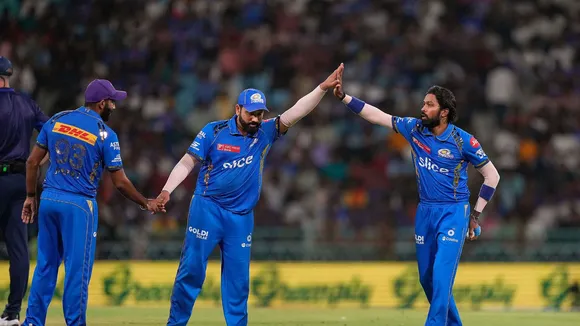 Mumbai Indians captain Hardik Pandya with teammate Rohit Sharma celebrates the wicket of Lucknow Super Giants batter Deepak Hooda, in Lucknow