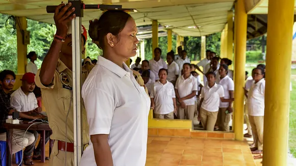 A woman police personnel gets her height measured during a Body Mass Index (BMI) assessment for Assam Police personnel, in Guwahati