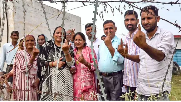 Voters show their inked fingers at a polling station during the second phase of J & K Assembly polls, in Nowshera, in Rajouri district, Wednesday, Sept. 25, 2024.