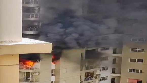 Smoke billows out after a fire broke out in the Lotus Boulevard Society at Sector 100 in Noida, Thursday, May 30, 2024