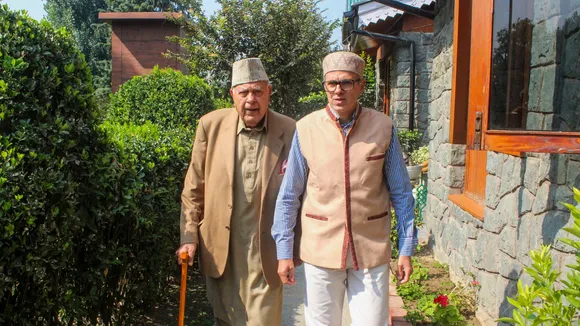 Jammu & Kashmir National Conference (JKNC) President Farooq Abdullah with his son and party Vice President Omar Abdullah, in Srinagar, Wednesday, Oct. 9, 2024.