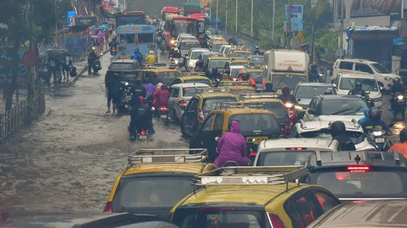 Vehicles move on a waterlogged road after heavy monsoon rain, at Dadar in Mumbai, Sunday, July 21, 2024.