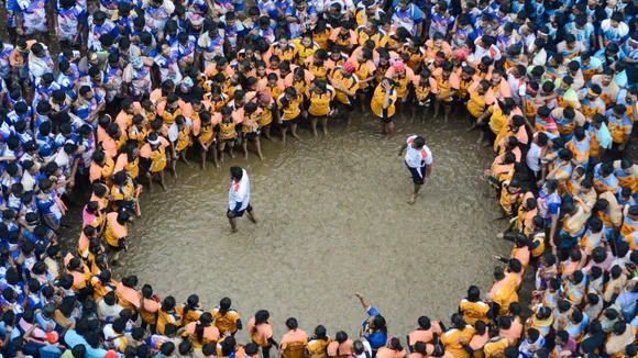 Devotees form a human pyramid to break the 'dahi handi' during Janmashtami celebrations, in Thane, Tuesday, Aug. 27, 2024.