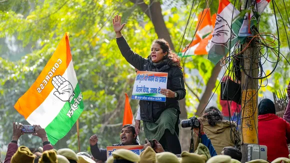 Police personnel stand guard as Congress workers protest over the IIT-BHU sexual assault case, in Lucknow