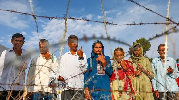 People show their inked fingers after casting their votes during the sixth phase of Lok Sabha elections, along the Line of Control (LoC) at Nowshera, in Rajouri district, Saturday, May 25, 2024