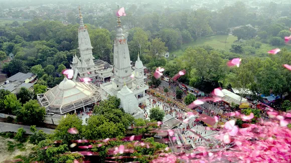 Flower petals being showered from a helicopter on Kanwariyas, at Augharnath Temple in Meerut.