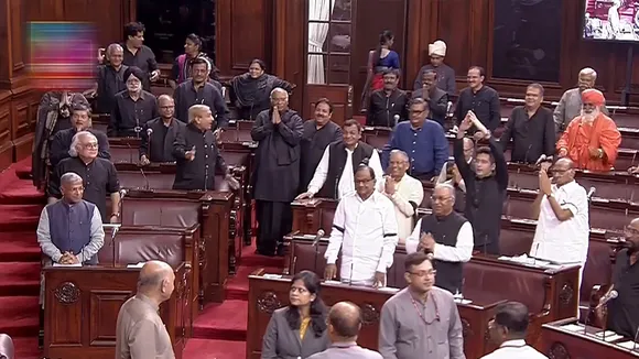 Parliamentarians welcome Rajya Sabha Chairman Jagdeep Dhankhar (unseen) in the House during the Monsoon session of Parliament, in New Delhi