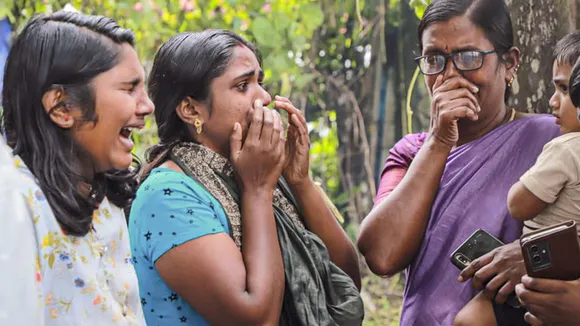 Family members and relatives of the recent landslides victims mourn at a crematorium, at Chooralmala, in Wayanad district