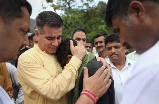 Jammu and Kashmir BJP President Ravinder Raina meets the family members of Deepu Kumar during his last rites, in Udhampur district