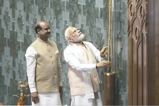 Prime Minister Narendra Modi installs the 'Sengol' in an enclosure on the right side of the Speaker's chair in the Lok Sabha chamber at the inauguration of the new Parliament building