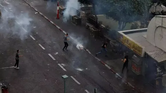 Videos posted to social media showed local youths pelting a a Palestinian military-style jeep with bricks, stones and metal bars before chasing the vehicle from the central Martyrs Square