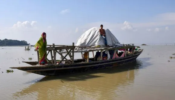 Villagers take shelter on an abandoned boat, at the flood-affected Chanaka village, in Morigaon district