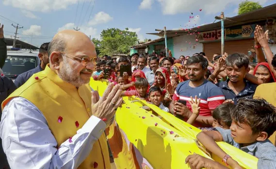 Union Home Minister Amit Shah being welcomed by supporters during the inauguration of Pt Deendayal Milan Center, in Virochnanagar on Monday